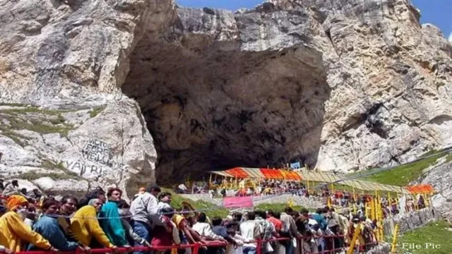 Ladoos and dynamic lines of devotees during Amarnath Yatra 2026 walking towards the holy cave shrine amidst rain.
