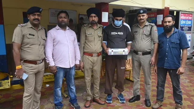 Police team standing with the seized Eon car after the Haridwar Retired Army Man Arrested event in Roorkee.