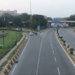 Delhi AQI recorded at 179 near AIIMS showing smoggy skyline and air quality status.